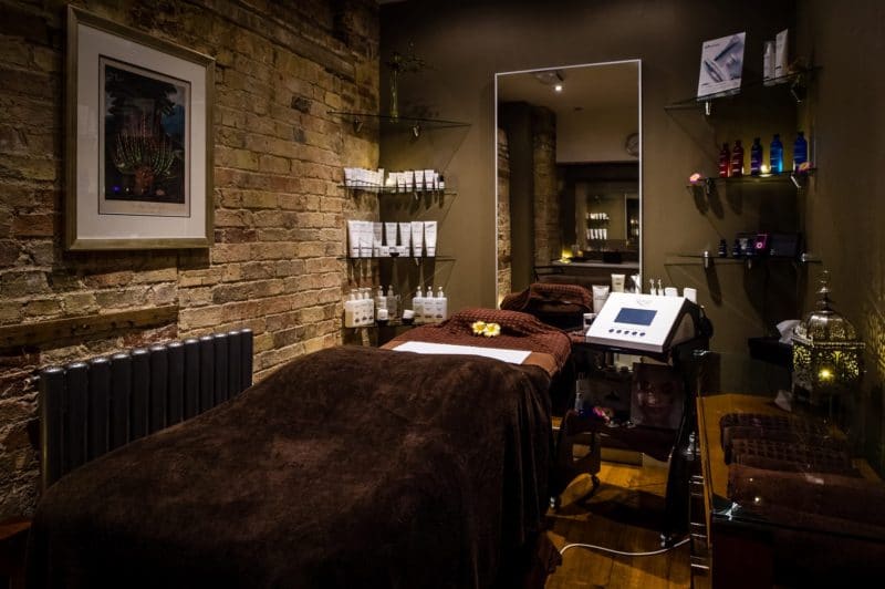 spa bed with elemis products, dimmed lights