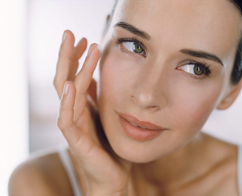 woman touching her face