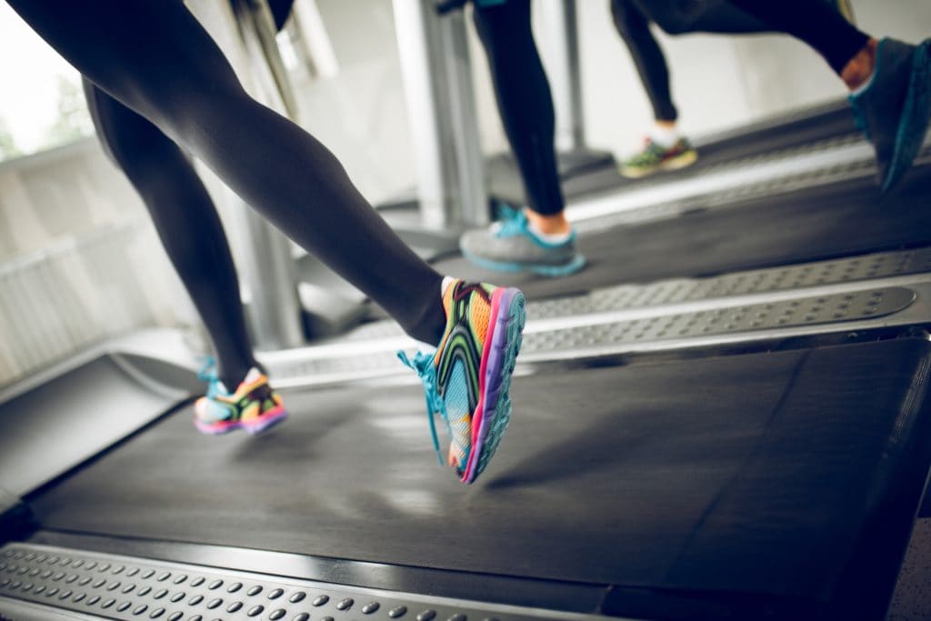 People running on treadmills in a gym